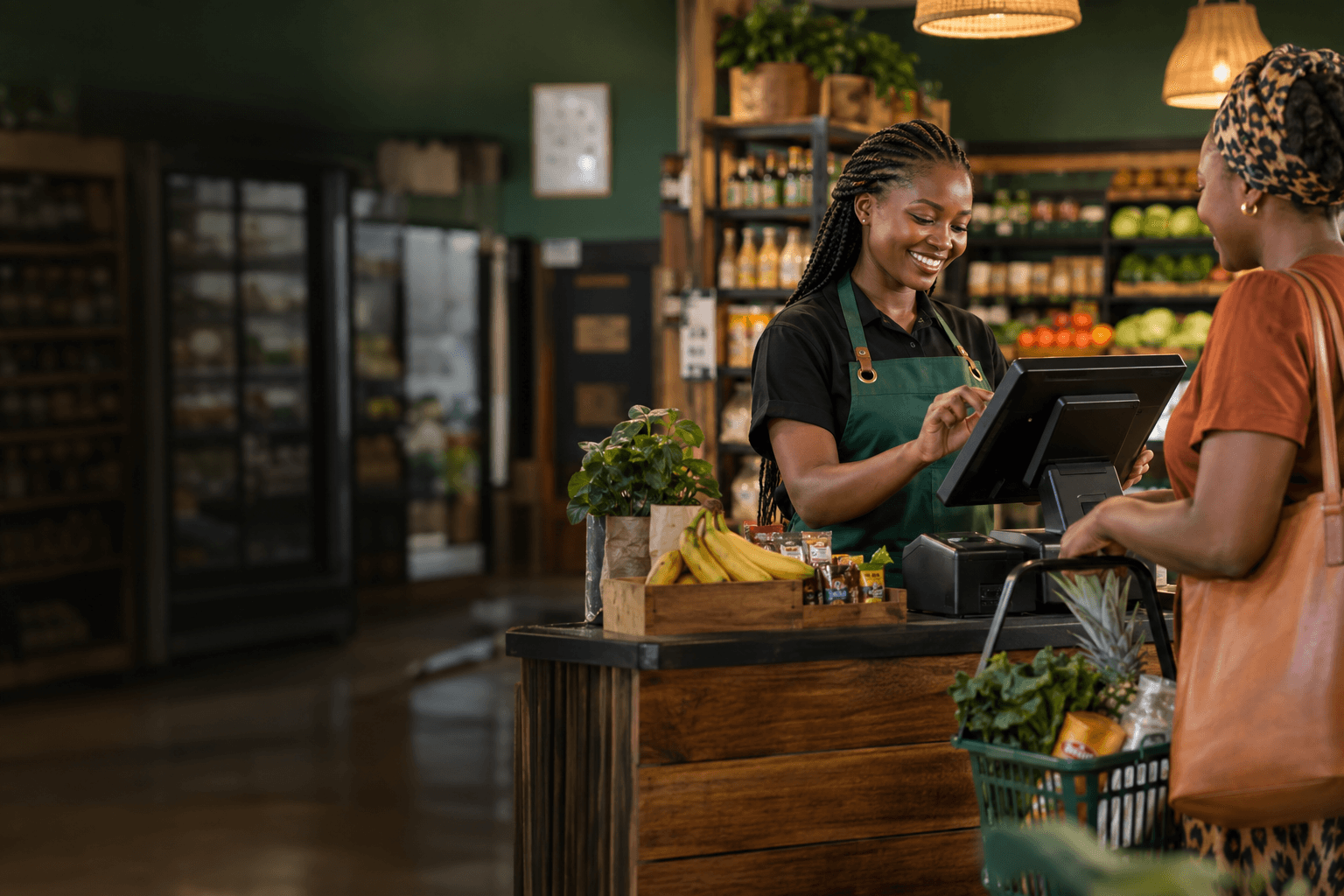 A Kenyan shop owner serving a customer at her point of sale